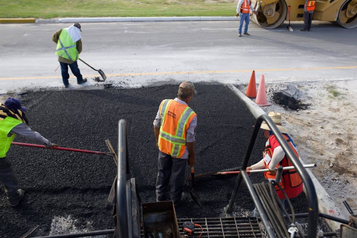 Paving crew working with fresh asphalt